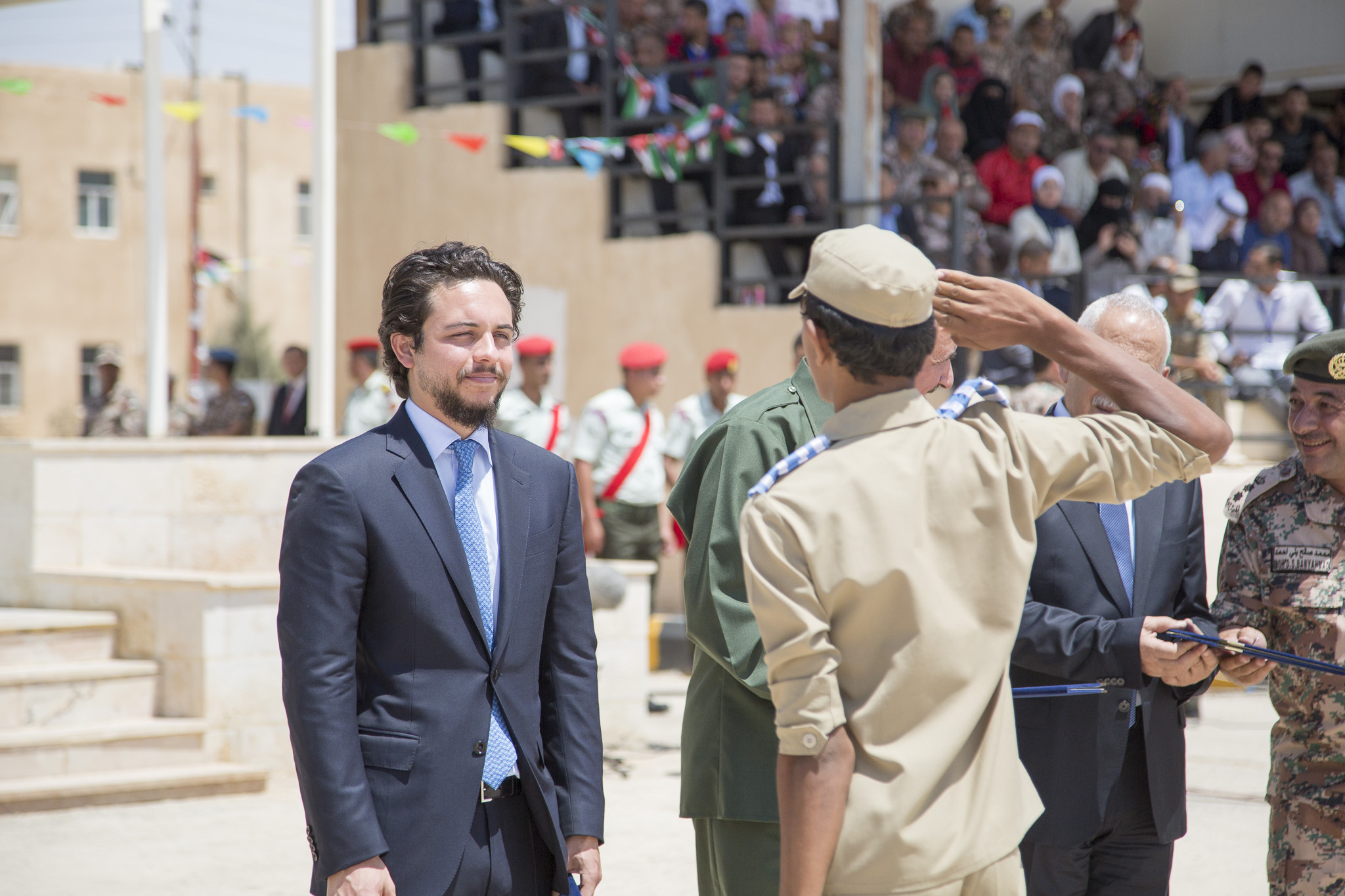 HRH Crown Prince Hussein is saluted by a graduate in the second class of the national training programme for school students during a ceremony at the central region's military conscription centre on Thursday (Photo courtesy of Royal Court)